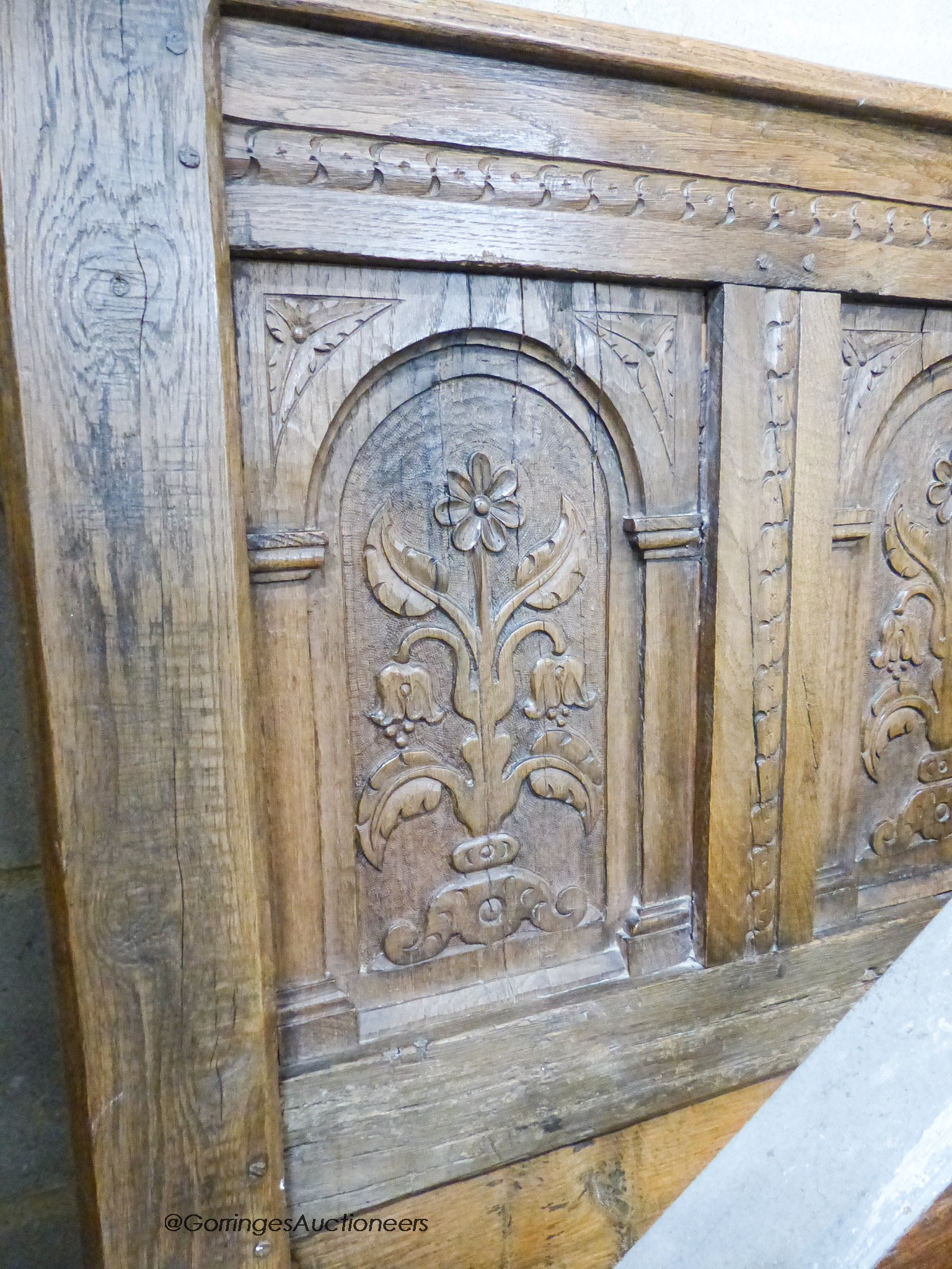 A pair of late 19th century panelled oak single bedsteads with floral carving, width 108cm, height 156cm